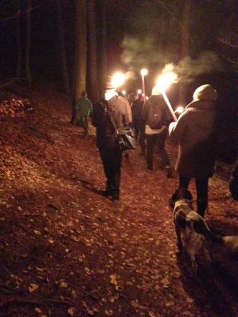 Hikers with torches walking to the Humberg Tower